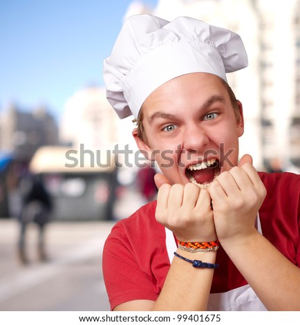 portrait of young cook man screaming at street