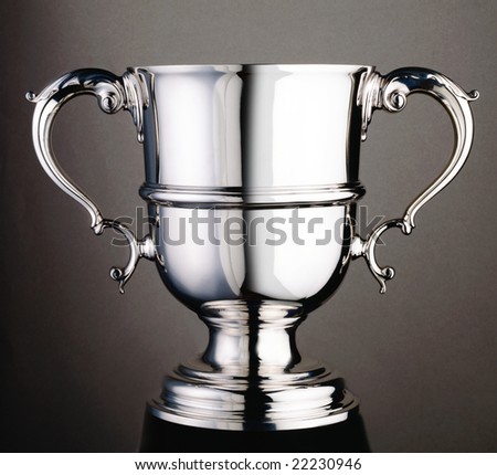 Silver trophy cup on a grey seamless background
