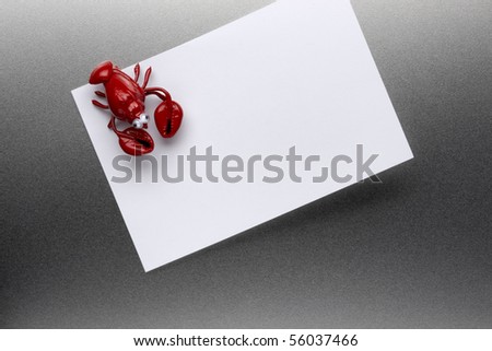 Lobster refrigerator magnet holds blank piece of paper to stainless steel refrigerator door includes space for copy
