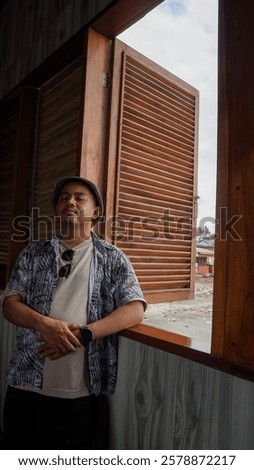 Image, Stock Photo Contemplative Asian man leaning on hand against brick building