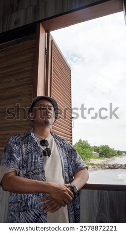 Similar – Image, Stock Photo Contemplative Asian man leaning on hand against brick building