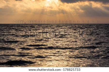 Sunset over an offshore wind power station in the Baltic Sea
