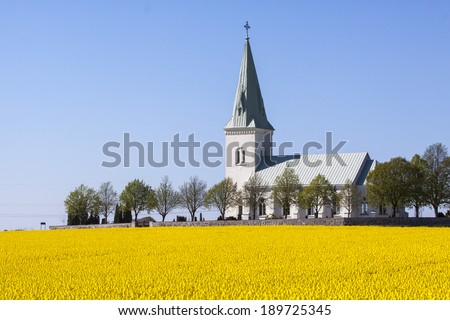 Country Church in South Sweden. Church of South Akarp. Here with field of rape in the foreground. Popular wedding church.