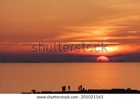 Sunset over Copenhagen Denmark with an audience on the other side of Oresund