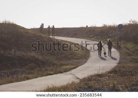 People on walking tour in weak light of winter