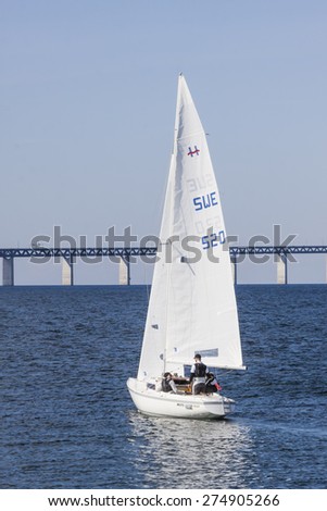 LIMHAMN, SWEDEN - APRIL 06, 2015: The first sailing on Oresund after Winter. The bridge between Denmark and Sweden, Oresundsbron, in the background.