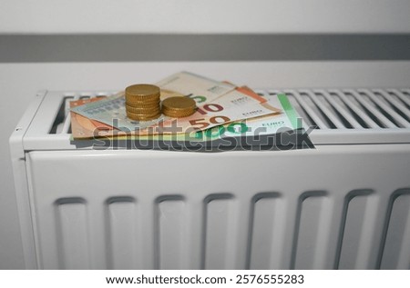 Similar – Image, Stock Photo euro banknotes on radiator as concept for rising heating costs and gas price crisis