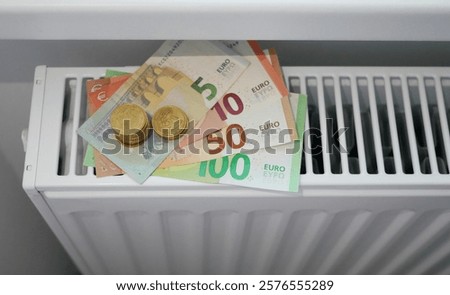 Similar – Image, Stock Photo euro banknotes on radiator as concept for rising heating costs and gas price crisis