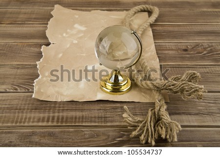 globe and old paper on a wooden table