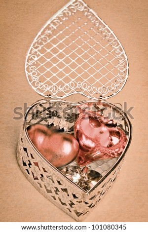 Valentines or anniversary gift of romantic hearts nestled inside a delicate silver filigree heart-shaped gift box