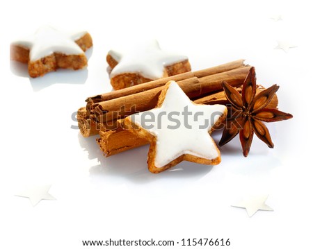 Christmas spices and stars still life with delicious star-shaped cookies, cinnamon sticks and star anise on a white background