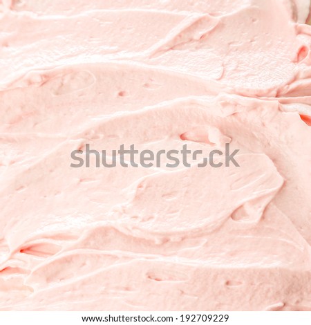 Creamy pink berry ice cream or frozen yoghurt background for a delicious cold summer treat, texture detail
