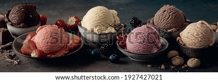 Wide angle of assorted gelati with tasty berries near cookies and grated chocolate on table