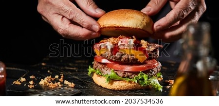 Similar – Image, Stock Photo Chef preparing burgers at grill plate on international urban street food festival.