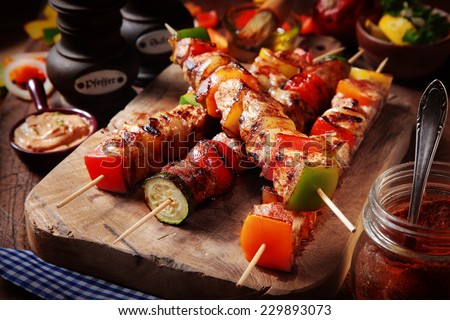 Close up Mouth Watering Gourmet Barbecue on Wooden Chopping Board at the Table.