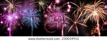 Colorful fireworks display of rockets bursting in a shower of fiery trails and sparks in a night sky to celebrate a festival or holiday such as New Year or Day of Independence