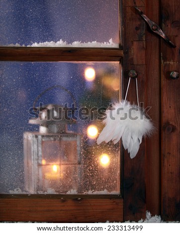 Close up Pure White Feathers Hanging on Vintage Wooden Window Pane During Christmas.