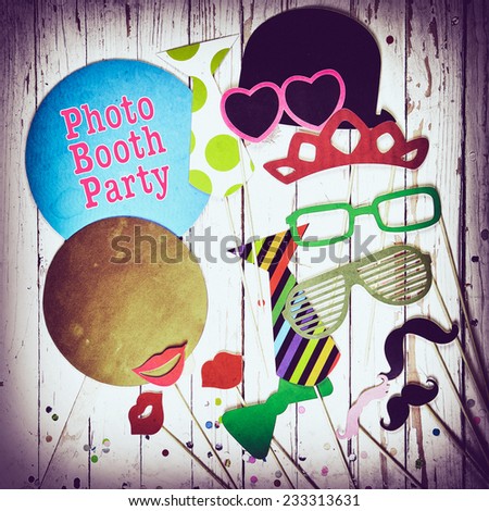 Fun photo booth party background with colorful paper fashion accessories, lips, moustaches and balloons with text - Photo Booth Party - surrounded by a vignette, square format