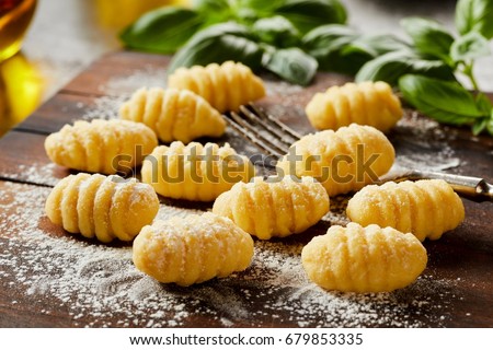 Similar – Image, Stock Photo Homemade gnocchi preparation on rustic kitchen table with ingredients. Top view. Potatoes dough . Italian food concept.