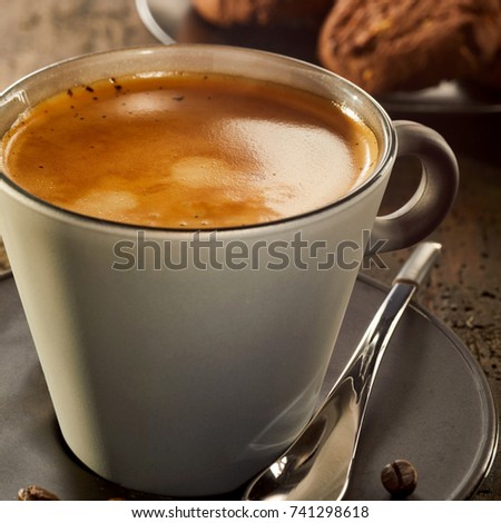 Cup of coffee crema in close up view with cookies on table in background ストックフォト © 