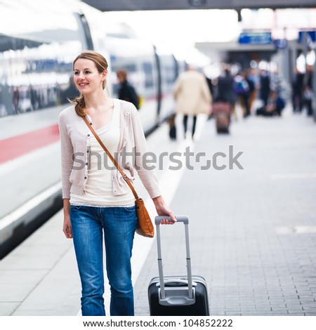 Pretty young woman at a train station (color toned image)