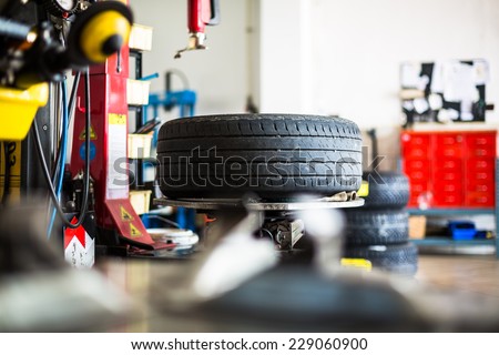 Inside a garage - changing wheels/tires (shallow DOF; color toned image)