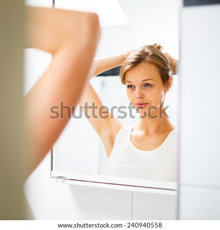 Pretty, young woman  in front of her bathroom during her morning routine (shallow DOF)