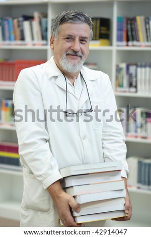 Renowned scientist/doctor in a library of research center/hospital holding many books and looking confident