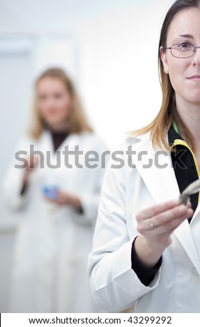 Two female researchers carrying out research in a chemistry/biochemistry lab