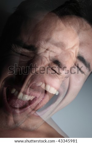 scream - young man\'s face deformed by a scream of anger/desperation/pain/rage (color toned image)