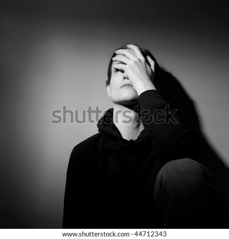 Young woman suffering from severe depression/anxiety  (B&W image)