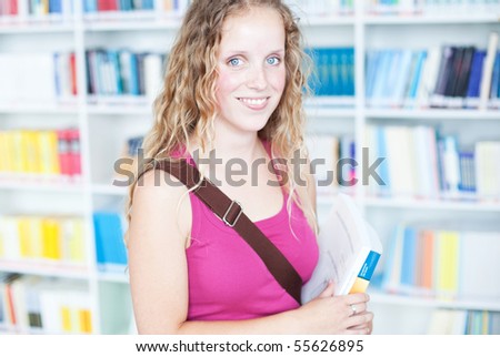 pretty female college student in a library