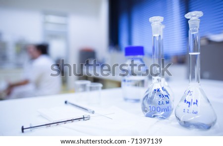 chemistry research center lab (shallow DOF; focus on the glassware in the foreground)