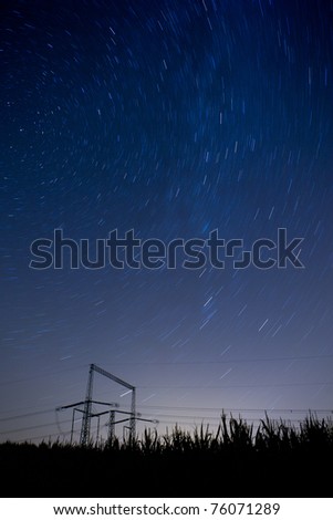 starry night landscape with high voltage poles (color toned image)