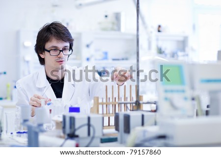 young male researcher carrying out scientific research in a lab (shallow DOF; color toned image)young male researcher carrying out scientific research in a lab (shallow DOF; color toned image)