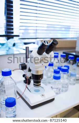 chemistry lab (shallow DOF; focus on the beakers in the foreground)