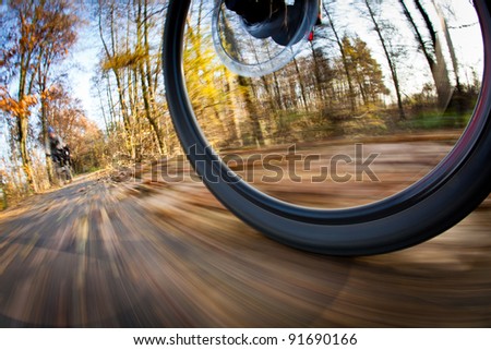 Bicycle riding in a city park on a lovely autumn/fall day (motion blur is used to convey movement)