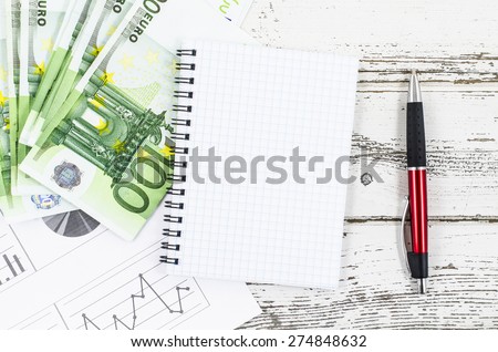 Empty notebook with business tools on wooden table