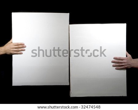 Strong hands hold white boxes on a black background
