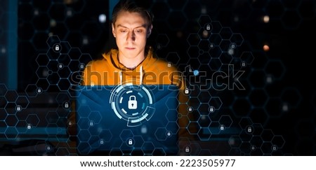A man works on a laptop, takes care of the security of his data, business information, sets up authentication, protection and a password on his device. Padlock sign in digital space, cyber security Foto d'archivio © 