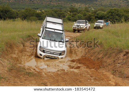 BAFOKENG - MARCH 8: White Ford Ranger XLS with Silver Canopy crossing water obstacle at Leroleng 4x4 track on March 8, 2014 in Bafokeng, Rustenburg, South Africa