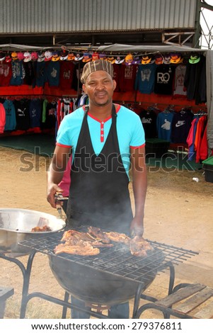 RUSTENBURG, SOUTH AFRICA - MAY 25: African man busy with barbecue  at Rustenburg Fair on May 25, 2014 in Rustenburg South Africa.