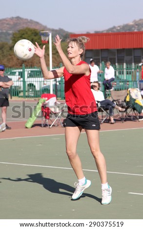 RUSTENBURG, SOUTH AFRICA - June 6:  Korfball League games played at Olympia Park on June 6, 2015 in Rustenburg South Africa.  Ladies team:  Girl goal trowing ball at net.