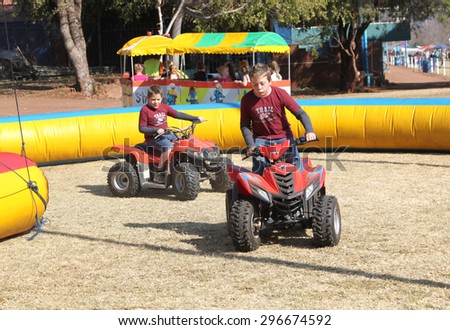 THABAZIMBI, SOUTH AFRICA - JUNE 28: Boys riding on quad bikes at Wildsfees (Game Festival) on June 28, 2014 in Thabazimbi South Africa.