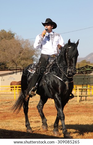 THABAZIMBI, SOUTH AFRICA - August 1:  Thabazimbi Agricultural Show, on August 1, 2014 at Thabazimbi, South Africa. Armand the singing cowboy on his black stallion.