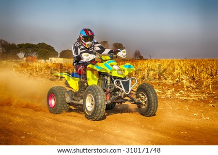 KOSTER, SOUTH AFRICA - July 11:  Africa-Offroad Racing Rally,  on July 11, 2015 at Koster, North West Province, South Africa.  hd Quad Bike kicking up trail of dust on sand track during rally race.