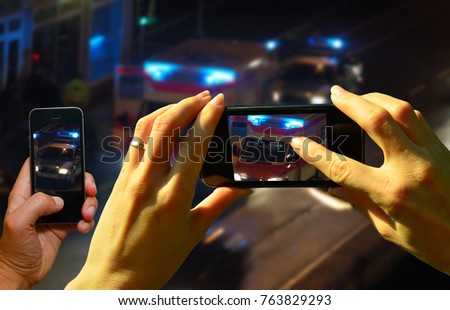 Onlookers film an accident scene with the cell phones Foto stock © 