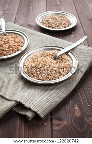 Sesame seeds dish in cloth on wood table