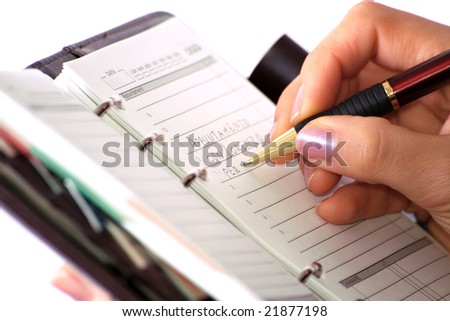 Woman in business writes on her agenda