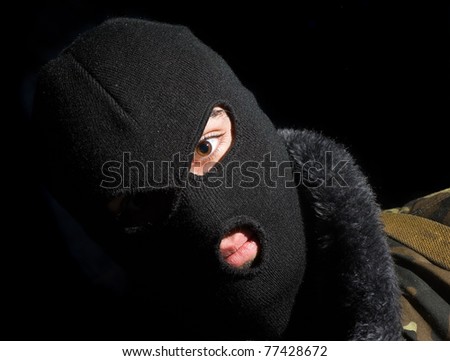 mask commando.portrait of man in a face-guard on a black background